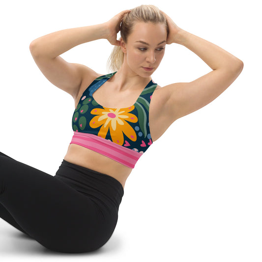 Athletic white women with doing a sit-up wearing a sport bra with flowers designs that have a big yellow flower