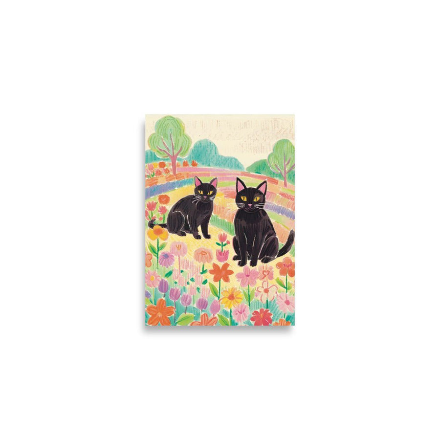 kitties in a Rainbow field Art Print shows 2 black cats looking forward in a colorful field fill with flowers and trees. 